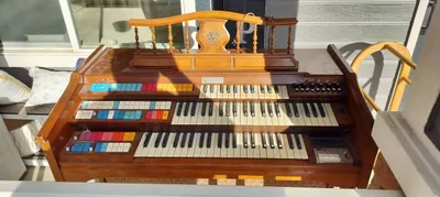 Wurlitzer Custom Funmaker 555 console showing dual manuals, colorful tab stops, and Orbit III controls