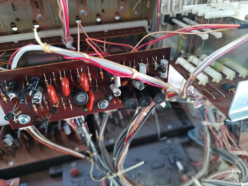 Voicing filter board — discrete components including resistors, ceramic disc capacitors, and electrolytics on a brown PCB