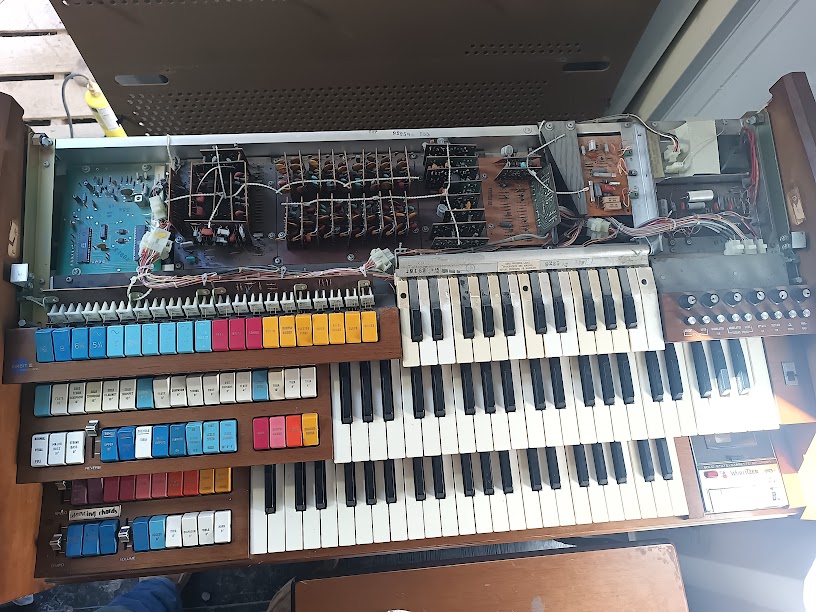 Console opened — top cover removed, stoprail pivoted, keyboards and circuit boards exposed