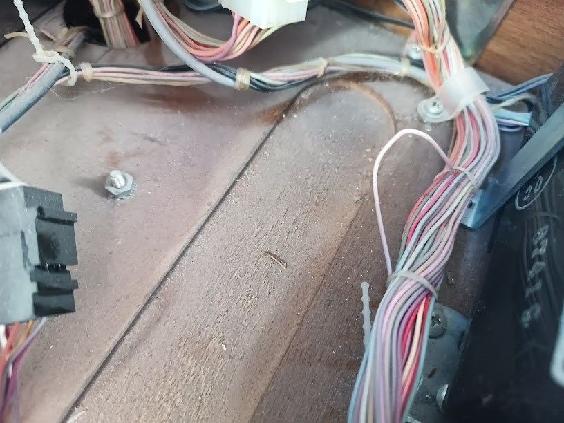Wire bundle caught between keyboard tilt point and chassis — possible insulation damage